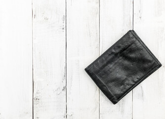 black leather wallet on wood board background