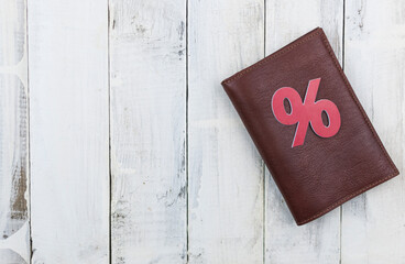 brown leather wallet on wood board background