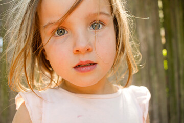 Close-up portrait of a young female child looking at camera