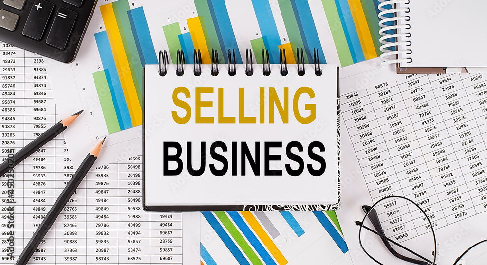 Poster closeup a notebook with text selling business , business concept image on chart background