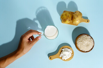 Powdered vegan milk made from potatoes and rice. Top view of the blue background.