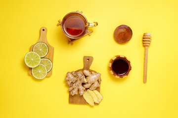 Various dried fruits lime ginger honey tea, on a yellow background. Top view. Flat lay