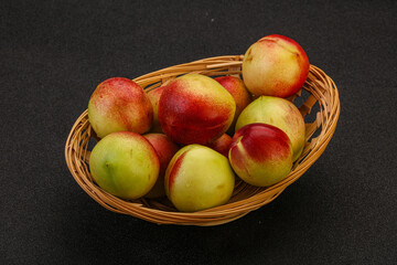 Sweet small nectarines in the basket