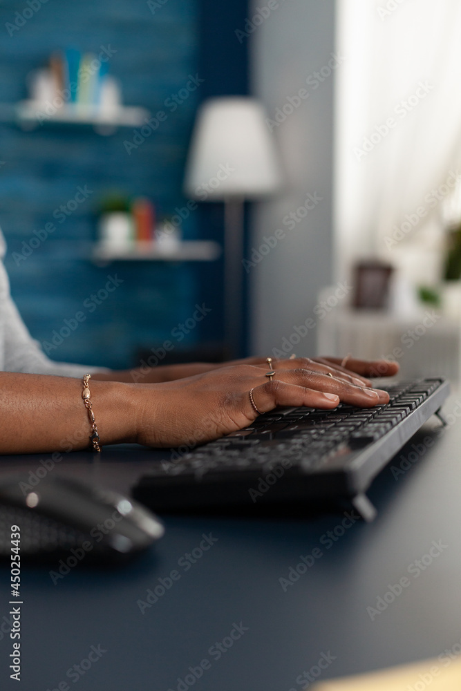 Poster closeup of black student working remote at education project typing information on keyboard using co