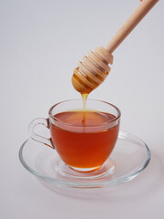 Honey pot and ladle isolated on a white background as a packaging design element