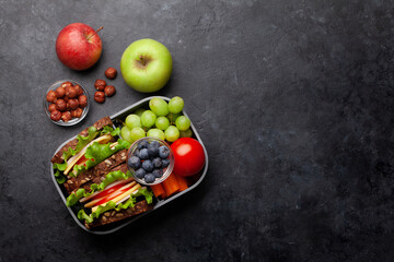 Healthy school lunch box with sandwich and fresh vegetables