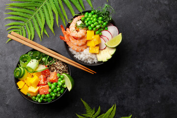 Poke bowls with shrimps, salmon, avocado and mango