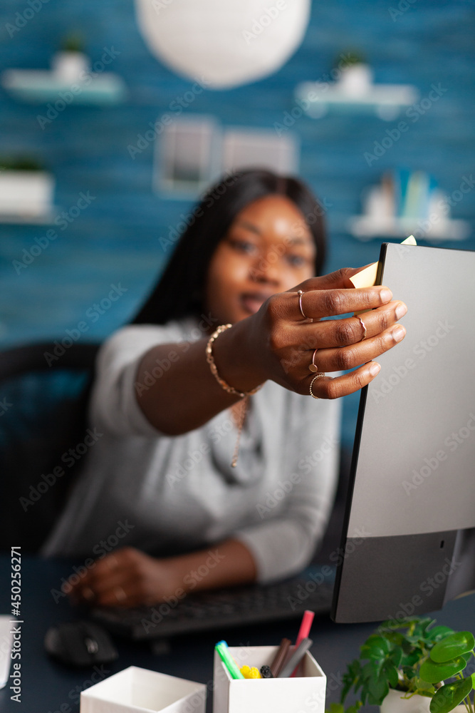 Poster student with dark skin putting stickey notes on computer studying communication lesson using univers