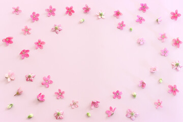 Plakat Top view image of pink flowers composition over pastel background .Flat lay