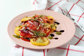 Concept of tasty food with tomato carpaccio on white background