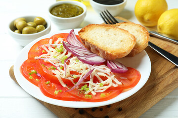 Concept of tasty food with tomato carpaccio on white wooden table