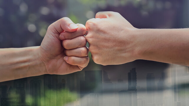 Double exposure  close up image of  Man hand a fist bump together in vintage tone