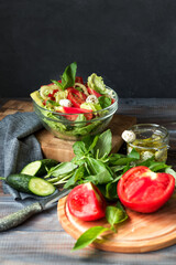 Vegetable salad with mozzarella cheese. Salad of fresh tomatoes, cucumbers, basil, pepper. Lunch of fresh vegetables. Tomatoes and mozzarella. Italian food