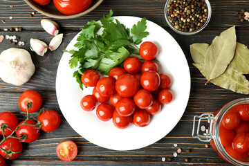 Concept of pickled vegetables with tomatoes on rustic wooden table