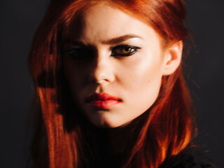 pretty red-haired woman bright makeup face close up studio