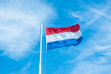 Fahne der Niederlande weht im Wind an einem Fahnemast
