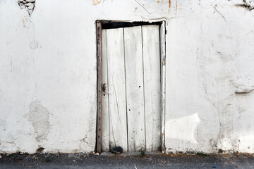 White wooden door of a slum house
