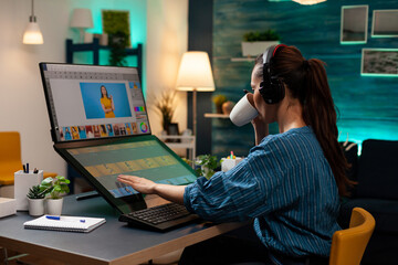 Woman with editor occupation wearing headphones at studio office desk. Professional graphic artist...