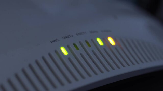 5G Era Connectivity and Internet of Things (IoT) concept. Close up of Wi-Fi 6 or WiFi 802.11ax access point and router LED indicate communication over 2.4 GHz and 5.0 GHz Band