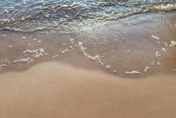 Soft wave of the sea on the sandy beach.Soft focus,blurred image.