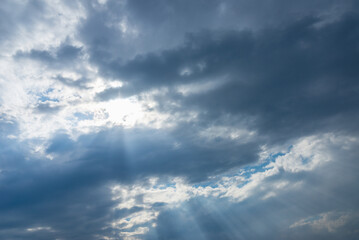 Obraz premium Dramatic blue sky with clouds and sun rays.Summer Sun rays at sunset.