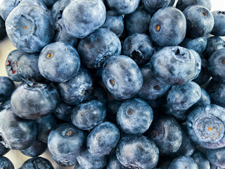 Photo blueberry. Macro huckleberry. Berry background. A handful of berries. Ripe wild berries