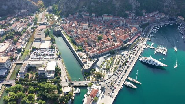 Old town Kotor Montenegro on the coast of Boka bay in the Mediterranean. Vacation destination and tourist trap in Europe. Aerial drone view on a sunny summer day.