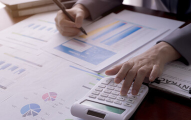 Businesswoman calculates income reports, taxes, losses, finance. Business and accounting concept.