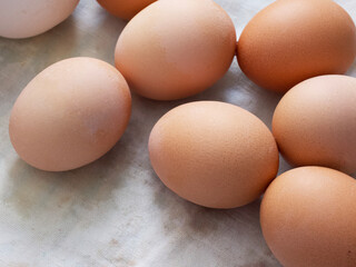 Chicken eggs lie on a fabric surface, close-up. Multi-colored chicken eggs.