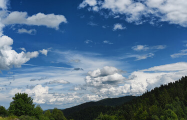 Clouds over the Ochotnica Gorna vilage hills during summer day