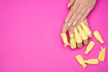A woman hand with set of plastic women nail art soak off cap clip UV gel polish remover wrap tool...