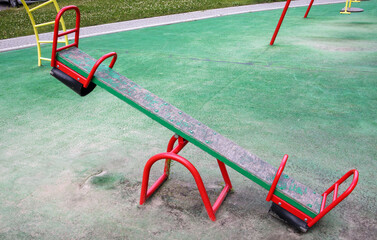 Closed modern playground. Security and protection measures against COVID-19 in the city park. Children's empty swing balancer in the park without people. The concept of childhood is over.