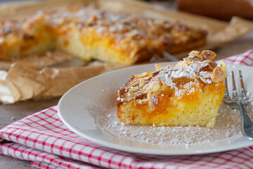 Almond cake with tangerines on a plate