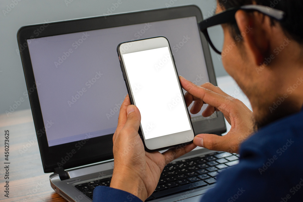 Poster man using smartphone looking on screen sitting in office work