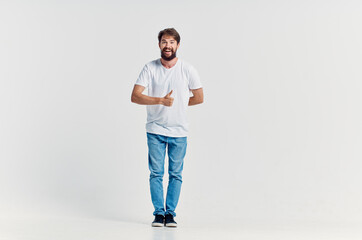 man in white t-shirt emotions posing light background