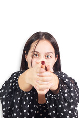 Naklejka premium Hispanic teenage girl playing shooting with lipstick. Cosmetic concept