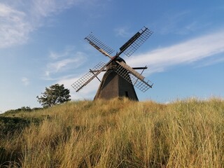 Fototapeta premium Old windmill in lush and green nature