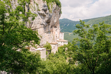 Fototapeta na wymiar Sanctuary of the Madonna della Corona is located in the hamlet of Spiazzi in the municipality of Ferrara di Monte Baldo, in the province and diocese of Verona, in a hollow dug in Mount Baldo.