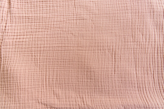 Soft Muslin Baby Blanket Background. Cotton Clothing And Textiles. Natural Organic Fabrics Texture. Light Pink Rose, Dusty Rose Color. Close Up. Top View