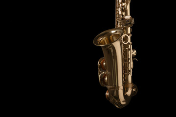 Beautiful saxophone on black background. Space for text