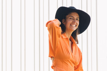 modern urban girl in hat smiling outdoors