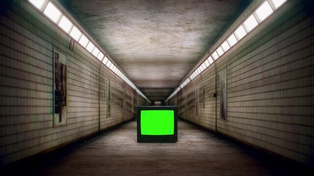 Green Screen TV Spooky Underground Corridor Subway Hallway Zoom In. Walking Through an empty eerie subway corridor with a green screen television. Scary scene