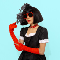 Demonic vampire gothic Lady in red gloves holding black roses. Role-playing games, halloween, party...