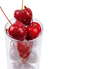 cherries in a glass on white background, copy space