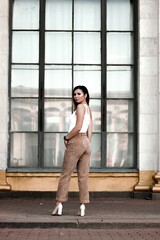 street style shot of a girl. photo of a young girl on the background of the building, columns.