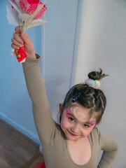 Young ballerina with a bunch of flowers