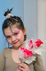 Little ballerina with a bouquet of flowers