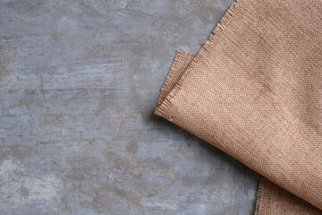 Background of sackcloth laid on a polished cement surface.