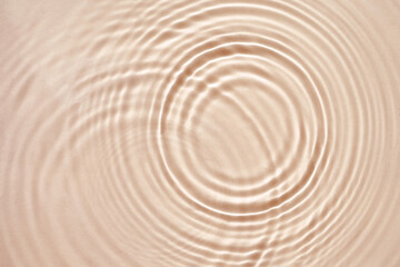 Beige cream texture with beautiful circles and ripples, abstract background for cosmetics