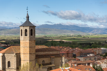 Fototapeta na wymiar Ávila / Spain - 05 12 2021: View at the Santiago church tower and surrounding view Ávila city downtown out at the fortress, Gredos mountains Regional Park as background